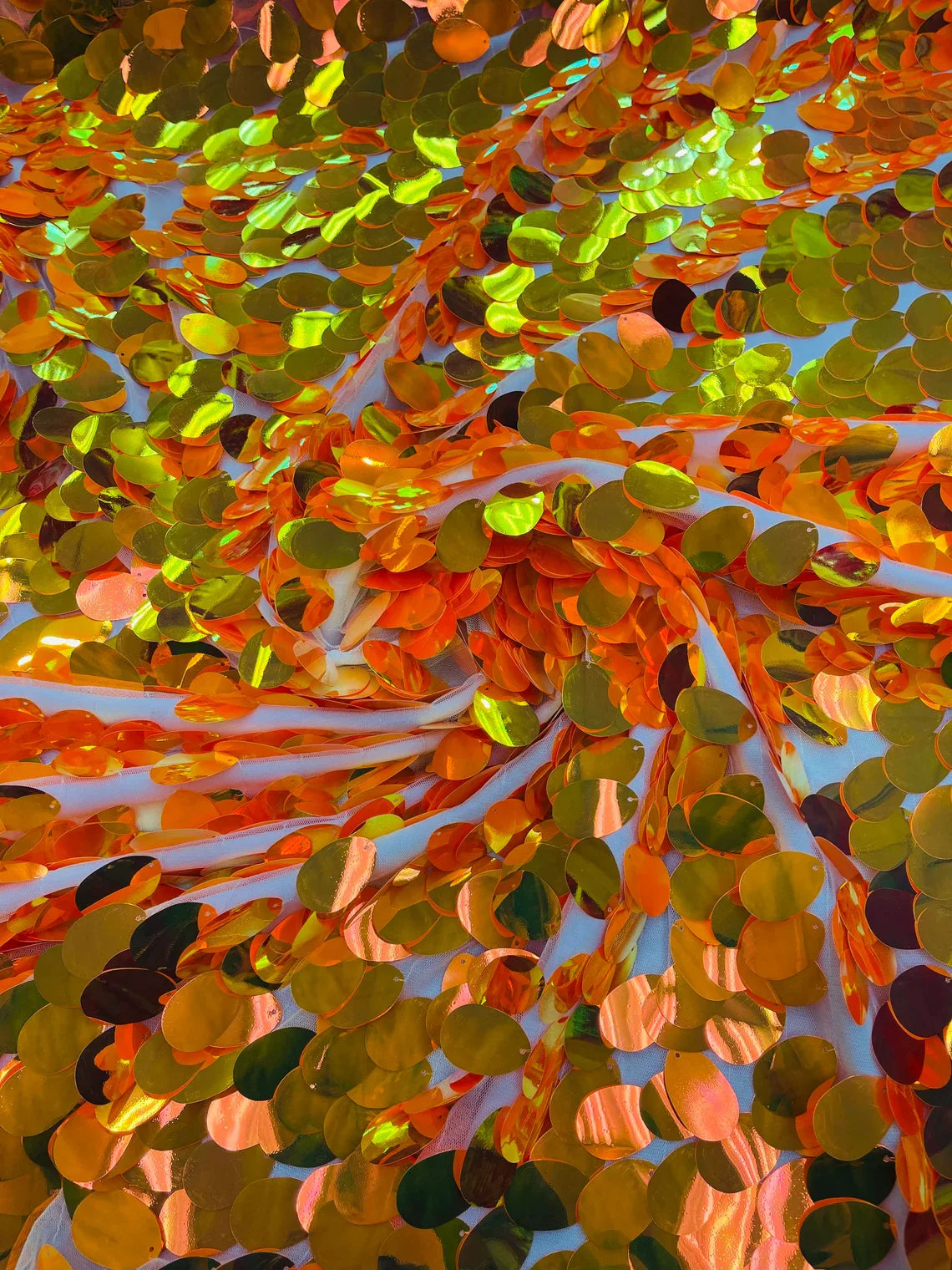 Iridescent Jumbo Oval Sequins - Orange Iridescent - Paillette Oval Sequins Fabric on White Mesh Sold By Yard