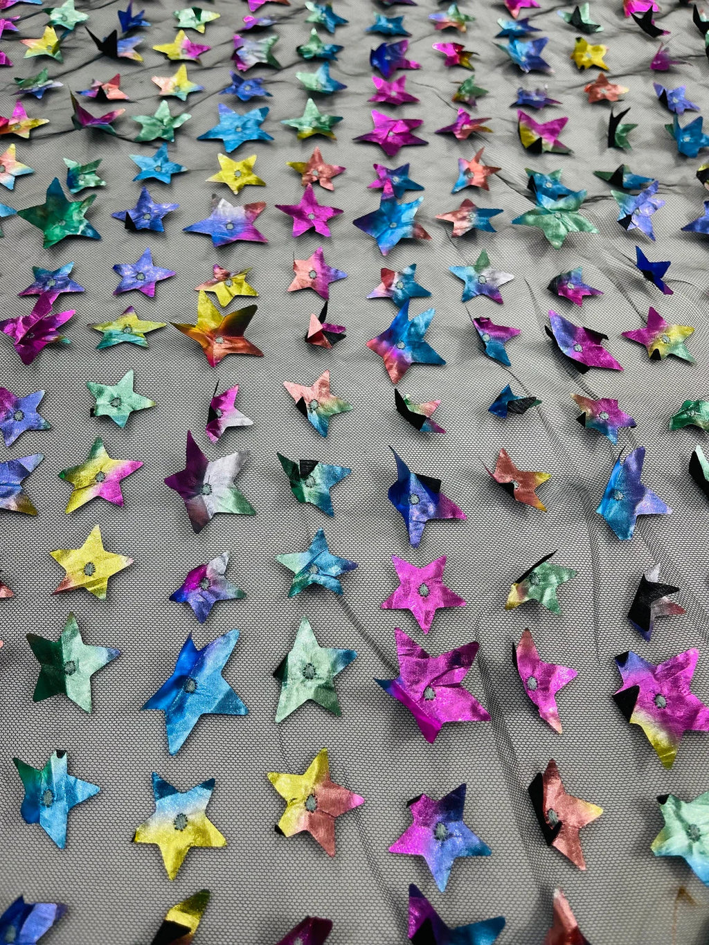 3D Holographic Rainbow Fabric - 3D Rainbow Foil Stars on Solid Black Mesh Sold By Yard
