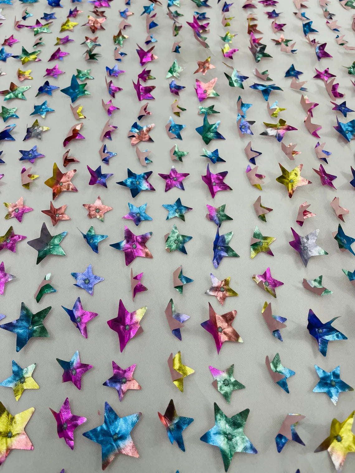 3D Holographic Rainbow Fabric - 3D Rainbow Foil Stars on Solid White Mesh Sold By Yard